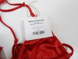 a red bag with a tag on it sitting on a table