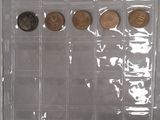 a lot of coins in a clear box on the table