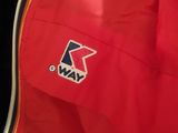 a close up of a red jacket with a logo on it