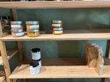 many jars of honey on the shelves in the store