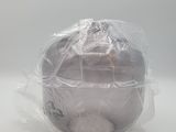 a plastic bag wrapped around a metal bowl on a table