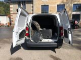 a white van with its doors open in a parking lot
