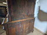 an old wooden bed in the corner of a room