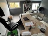 a desk with a chair and a book on it
