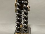a clock that is on a stand with a chain around it