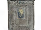 an old silver picture frame with a picture of a woman on it