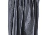 black skirt hanging on a hanger on a white wall