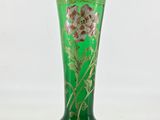 green glass vase with a floral design on the bottom