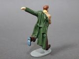 a figurine of a man in a green coat holding a cell phone