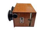 a small wooden box with a button on it