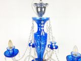 un lustre en verre bleu muni de trois ampoules