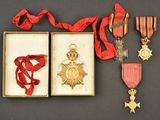 an assortment of medals including a medal, a star, and a ribbon