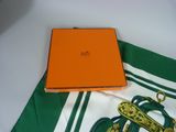 an orange box sitting on top of a green and white table cloth