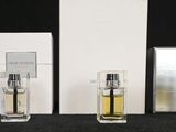 three bottles of perfume sitting next to each other on a table