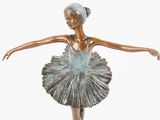 bronze statue of a ballerina in a tutu on a marble base
