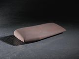 a pink soap bar sitting on the floor in the dark
