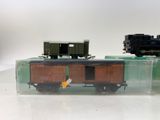 two toy trains sitting in a clear box on a table