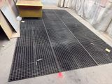 a metal grate on the ground next to a yellow box