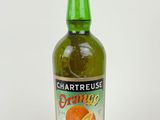 a bottle of orange juice sitting on a white surface