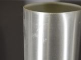 a close up of a metal vase on a table