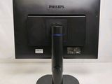a black computer monitor with a blue light on it