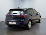 the back of a blue volkswagen e - pace parked in a showroom
