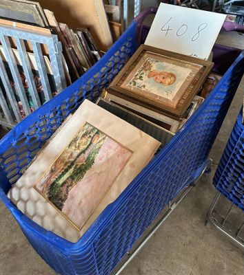 deux paniers bleus remplis de tableaux et de photos dans une pièce