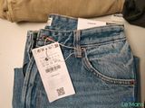 a pair of jeans with a price tag on them
