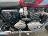 a red and black motorcycle parked in a parking lot