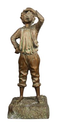 statue en bronze représentant un garçon tenant une batte de baseball, assis sur un rocher