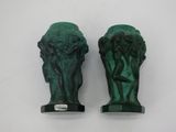 pair of green ceramic sculptures of a man and a woman
