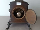 a small clock that is sitting on a table