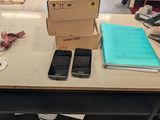 a table with a bunch of cell phones on top of it