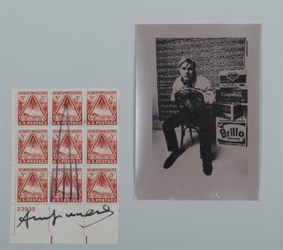an old photo of a man sitting on a chair next to a stamp