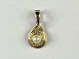 a yellow gold pendant with a pearl in the center