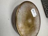 a picture of a vase on a table with a tag on it