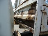 a white truck with rust on the side of it