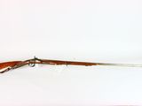 an old rifle with a wooden handle and a wooden barrel
