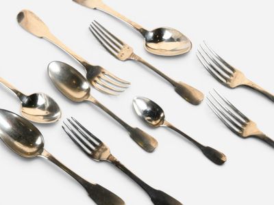 several spoons, forks and spoons are lined up on a white surface