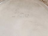 a silver plate with writing on it sitting on a table