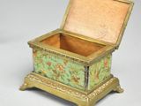a small box with a lid that has a floral design on it
