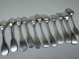 a lot of forks and spoons that are on the table