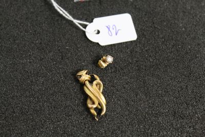 a close up of a gold necklace with a tag attached to it