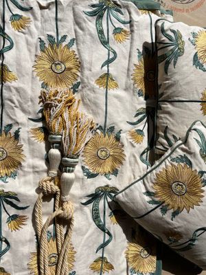 two pillows and a pillow with a tassel on them