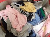 a box full of clothes that is sitting on the floor