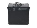 an electric guitar amplifier sitting on top of a white surface