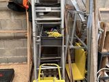 une petite machine jaune posée à côté d'un tas de bois