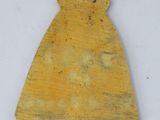 an old yellow piece of wood with a small hole in the middle of it