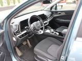 the interior of a car with the door open and the driver ' s seat down