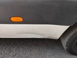 a close up of a car ' s bumper with an orange sticker on it